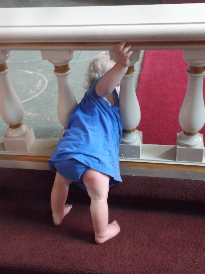 AnaClaire trying to climb through the communion rail.