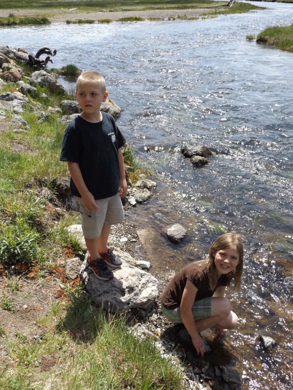 Isaac and Alex putting their hands in the water