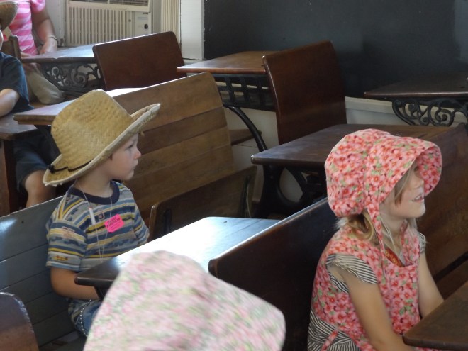 Dominic and Amelia sitting in the school listening to the teacher (Dominic never sits that still)